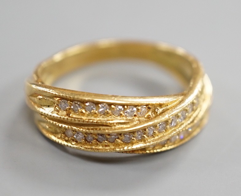 A modern 18ct gold and diamond chip set crossover ring, size N, gross weight 5.2 grams.